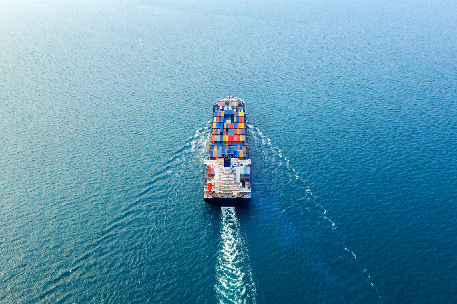 Aerial view of a container ship travelling across the sea