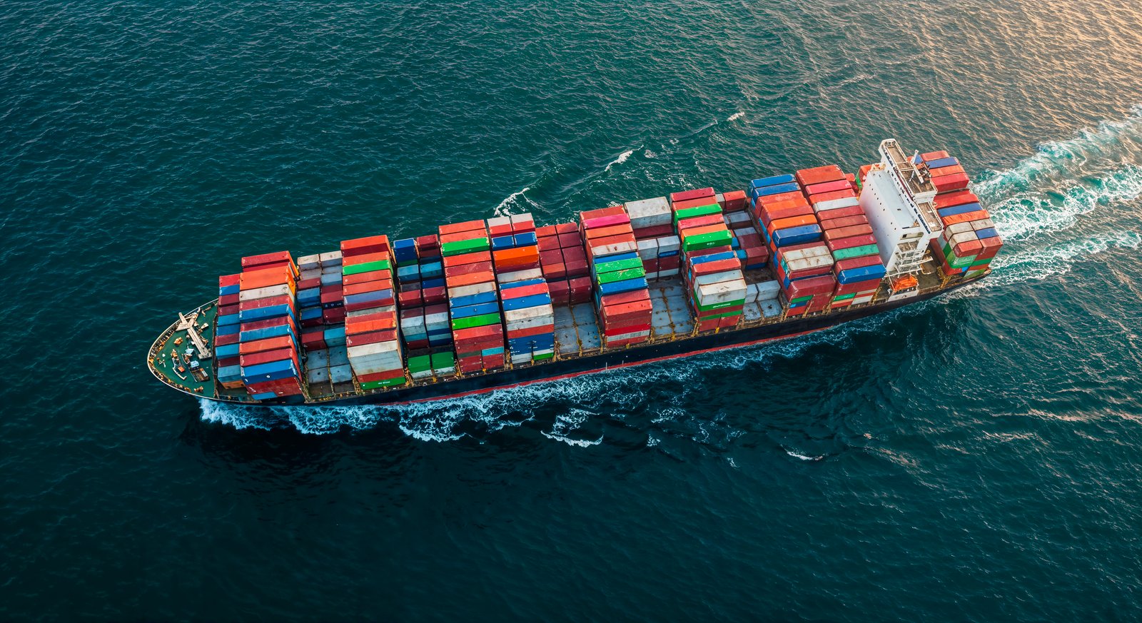 Cargo ship carrying shipping containers across the ocean